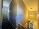 Upper hallway with gray walls, carpet, and chandelier at 4839 Alameda Rd, Indianapolis, IN 46228