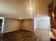 Open living room with dark hardwood floors and ceiling fan at 4839 Alameda Rd, Indianapolis, IN 46228