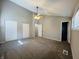 Spacious bedroom with neutral carpeting and ample closet space at 4839 Alameda Rd, Indianapolis, IN 46228