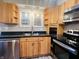 Modern kitchen with stainless steel appliances and wood cabinets at 4839 Alameda Rd, Indianapolis, IN 46228