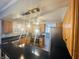 Modern kitchen with wood cabinets, black countertops and island at 4839 Alameda Rd, Indianapolis, IN 46228
