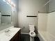 Main floor bathroom with tub, toilet and vanity at 4839 Alameda Rd, Indianapolis, IN 46228