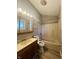 Bathroom with shower/tub combo and wood vanity at 4839 Alameda Rd, Indianapolis, IN 46228