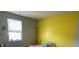 Bedroom with yellow and gray walls and window at 7625 Firecrest Ln, Camby, IN 46113
