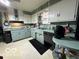 Galley kitchen with light green cabinets and appliances at 4434 E 46Th St, Indianapolis, IN 46226