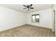 Bright bedroom with carpeted floor, window, and ceiling fan at 10881 Harbor Bay Dr, Fishers, IN 46040