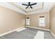 Spacious bedroom with carpeted floor, ceiling fan, and large windows at 10881 Harbor Bay Dr, Fishers, IN 46040