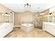 Elegant bathroom with double vanities, a large soaking tub, and a walk-in shower at 10881 Harbor Bay Dr, Fishers, IN 46040