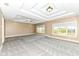 Bright main bedroom with large windows and a coffered ceiling at 10881 Harbor Bay Dr, Fishers, IN 46040