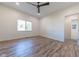 Simple bedroom with hardwood floors and ceiling fan at 1521 Indiana Ave, Columbus, IN 47201