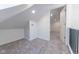Spacious attic bedroom with grey carpeting and an ensuite bathroom at 1521 Indiana Ave, Columbus, IN 47201