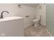 Clean bathroom with white toilet and sink, and a tiled shower at 1521 Indiana Ave, Columbus, IN 47201
