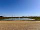 Community pond with fountain, landscape, and clear blue sky at 1114 Fleming Dr, Greenfield, IN 46140