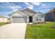 Two-story home with gray siding and attached garage at 1114 Fleming Dr, Greenfield, IN 46140