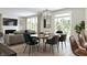 Bright dining room features a large table, modern chairs, and a view to the living room at 5714 Cloister Ln, McCordsville, IN 46055