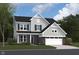 Two story house exterior with gray siding, stone accents, and a two car garage at 5714 Cloister Ln, McCordsville, IN 46055