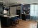 Kitchen with island, dark cabinets, and hardwood floors at 3991 Bennett Dr, Indianapolis, IN 46254