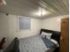 Basement bedroom with a queen-size bed and window at 3991 Bennett Dr, Indianapolis, IN 46254