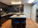 Kitchen with island, dark cabinets, and pot rack at 3991 Bennett Dr, Indianapolis, IN 46254