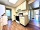 Kitchen with light cabinets, laminate flooring, and access to the bathroom at 1750 Linden St, Indianapolis, IN 46203