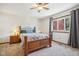 Cozy bedroom with a wooden bed frame, nightstands, and ceiling fan at 1724 Sunrise Cir, Indianapolis, IN 46229
