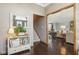 Elegant entryway with hardwood floors, a mirror, and a view of the staircase at 1724 Sunrise Cir, Indianapolis, IN 46229
