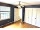 Spacious bedroom with hardwood floors, double doors, and blue walls at 7722 Shady Hills W Dr, Indianapolis, IN 46278