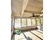 Bright and airy screened porch with wood floors and ceiling fan at 7722 Shady Hills W Dr, Indianapolis, IN 46278