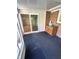 Sunroom with sliding glass doors, carpet, and built-in storage at 7722 Shady Hills W Dr, Indianapolis, IN 46278