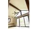Sunlit living room with vaulted ceilings, large windows, and hardwood floors at 7722 Shady Hills W Dr, Indianapolis, IN 46278