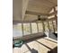 Bright sunroom with wooden floors and autumn views at 7722 Shady Hills W Dr, Indianapolis, IN 46278