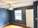 Charming bedroom with hardwood floors, window, and blue wallpaper at 7722 Shady Hills W Dr, Indianapolis, IN 46278