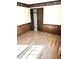 Spacious bedroom with wood-paneled walls and laminate flooring at 7722 Shady Hills W Dr, Indianapolis, IN 46278