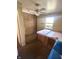Small bedroom with brick wall and ceiling fan at 7722 Shady Hills W Dr, Indianapolis, IN 46278