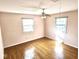 Charming bedroom with hardwood floors and two windows at 7722 Shady Hills W Dr, Indianapolis, IN 46278