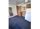 Sunroom features a refrigerator, brick wall, and carpet flooring at 7722 Shady Hills W Dr, Indianapolis, IN 46278