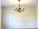 Dining room with chandelier and wainscoting at 7722 Shady Hills W Dr, Indianapolis, IN 46278