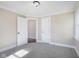 Well-lit bedroom with grey carpet and neutral colored walls at 1430 Walton St, Anderson, IN 46016