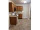 Kitchen with oak cabinets and tile floors at 8417 Abbey Dell Dr, Indianapolis, IN 46113