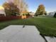 Large backyard with a wooden fence and patio at 8417 Abbey Dell Dr, Indianapolis, IN 46113