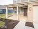 Front porch, covered entryway, and landscaped walkway of a two-story home at 3333 Stafford St, Sheridan, IN 46069