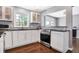 White Shaker cabinets, granite counters, and stainless steel appliances at 3005 Olive Branch Rd, Greenwood, IN 46143