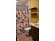 Bathroom with floral shower curtain and updated vanity at 2721 Del Prado Dr, Indianapolis, IN 46227