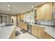 Modern kitchen with stainless steel appliances and light wood cabinets at 6502 Allisonville Rd, Indianapolis, IN 46220