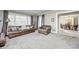 Spacious living room with leather furniture and views into the dining room at 6502 Allisonville Rd, Indianapolis, IN 46220