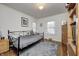 Cozy bedroom with double bed, built-in shelving, and hardwood floors at 6502 Allisonville Rd, Indianapolis, IN 46220