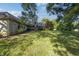 Landscaped backyard with large lawn and trees at 6502 Allisonville Rd, Indianapolis, IN 46220