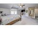 Large main bedroom with king bed, TV, and access to a hallway at 6502 Allisonville Rd, Indianapolis, IN 46220