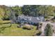 Stone house with patio, firepit, and large backyard. Triple car garage and basketball court at 6502 Allisonville Rd, Indianapolis, IN 46220
