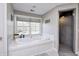 Bathroom featuring a large soaking tub and walk-in shower at 6502 Allisonville Rd, Indianapolis, IN 46220